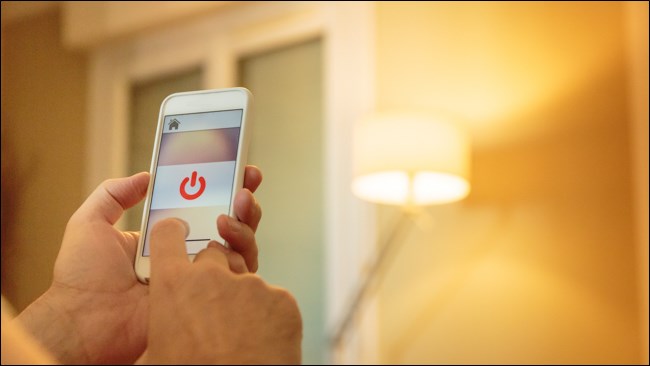 A hand using a Smart Light Controller on a Smartphone.