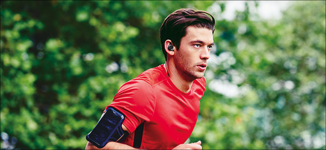 Man running with Bluetooth earbuds on.