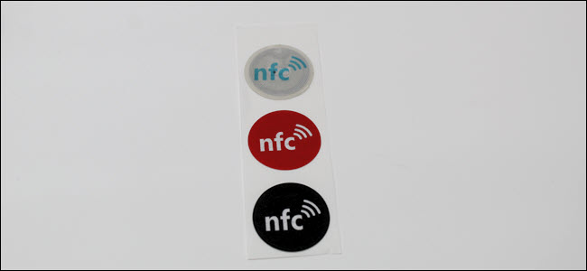 Three NFC tags on a paper strip.